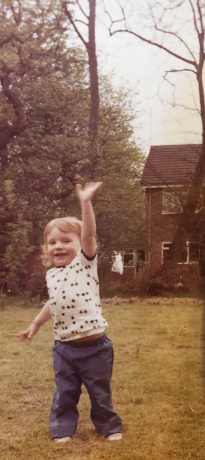 Young Helen Armstrong as a toddler, arm raised joyfully